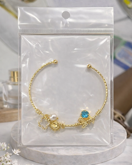 Gold Charm Open Cuff Bracelet – Sun, Pearl & Blue Crystal Design